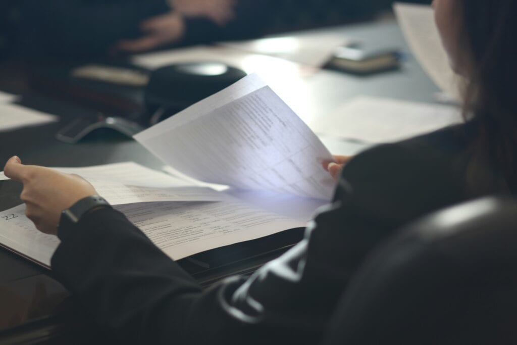 Person reviewing printed documents side by side at a desk